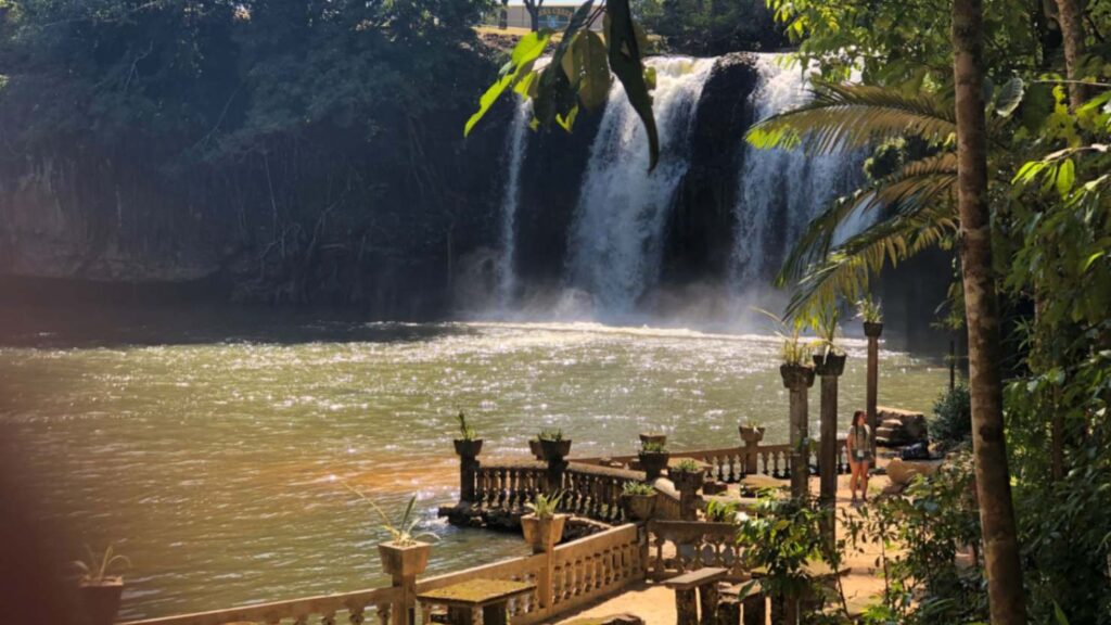 Waterfall view at Paronella Park near Cairns surrounded by lush rainforest